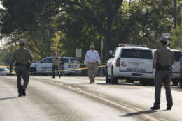 Law enforcement officers work near the First Baptist Church of Sutherland Springs after a fatal shooting, Sunday, Nov. 5, 2017, in Sutherland Springs, Texas. (AP Photo/Darren Abate)