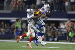 Dallas Cowboys safety Jeff Heath (38) intercepts a pass in front of Orlando Scandrick (32) intended for Kansas City Chiefs tight end Travis Kelce, rear, in the second half of an NFL football game, Sunday, Nov. 5, 2017, in Arlington, Texas. (AP Photo/Brandon Wade)