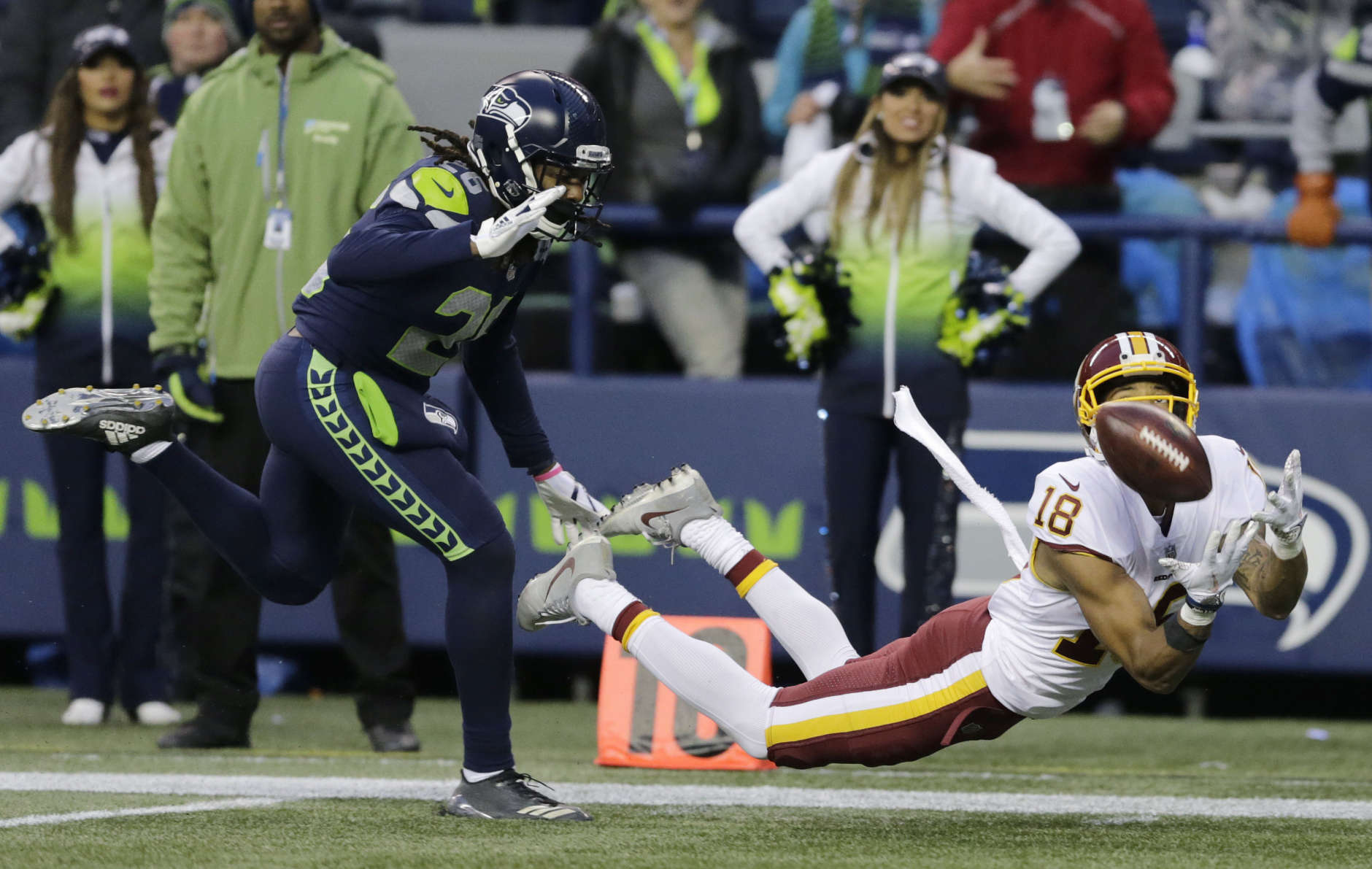 Washington Redskins wide receiver Josh Doctson, right, makes a diving catch ahead of Seattle Seahawks cornerback Shaquill Griffin, left, in the second half of an NFL football game, Sunday, Nov. 5, 2017, in Seattle. The Redskins won 17-14. (AP Photo/Stephen Brashear)
