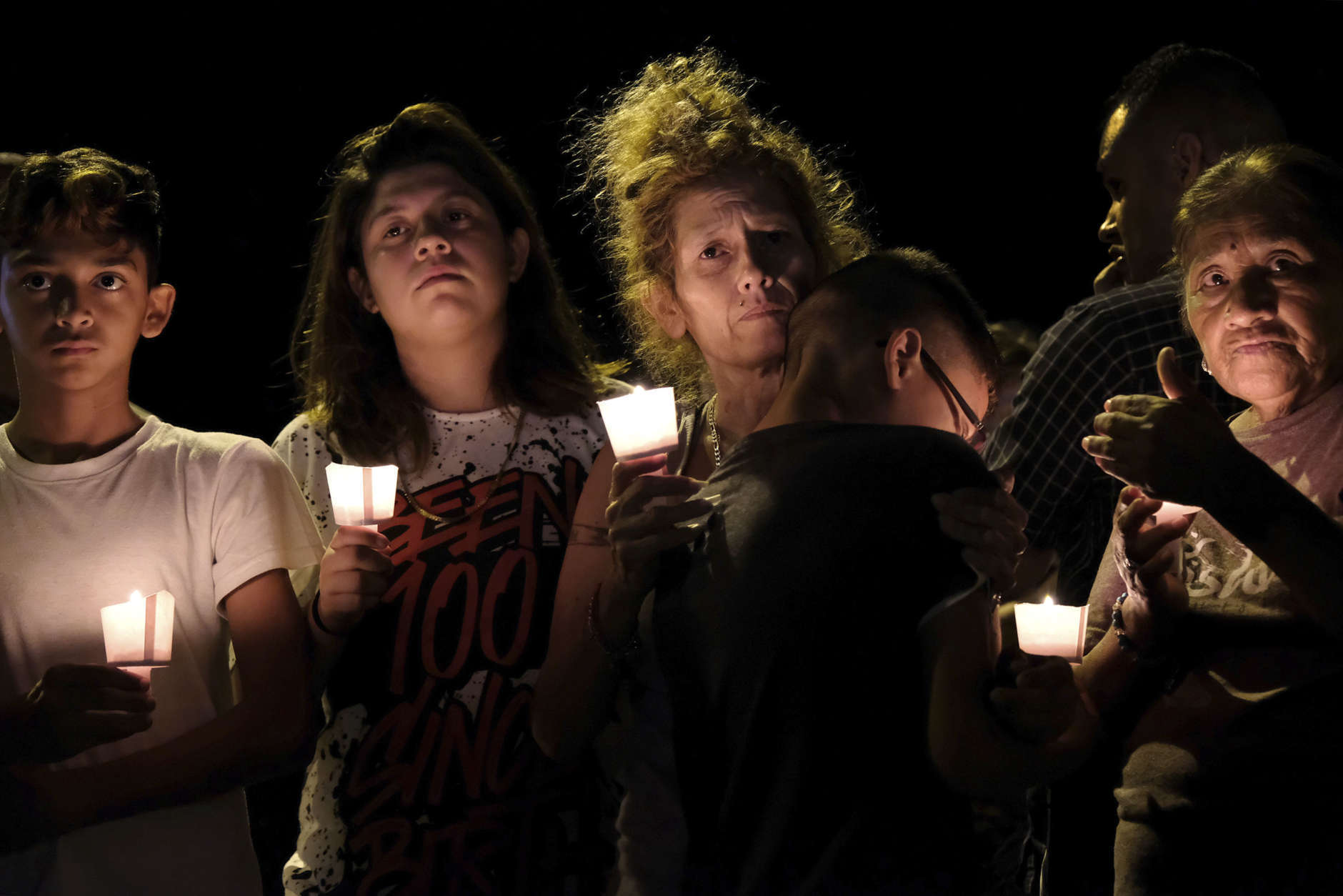 From left are Christopher Rodriguez, Esmeralda Rodriguez, Mona Rodriguez, Jayanthony Hernandez, 12, and Juanita Rodriguez participate in a candlelight vigil for the victims of a fatal shooting at the First Baptist Church in Sutherland Springs, Texas, Sunday, Nov. 5, 2017. (AP Photo/Laura Skelding)