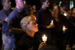 Texas Gov. Greg Abbott attends a candlelight vigil held for the victims of a fatal shooting at the First Baptist Church of Sutherland Springs, Sunday, Nov. 5, 2017, in Sutherland Springs, Texas. (AP Photo/Laura Skelding)