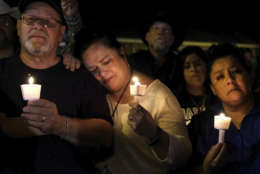 Community members come together for a candlelight vigil for the victims of a deadly church shooting in Sutherland Springs, Texas, Sunday, Nov. 5, 2017. A man opened fire inside of the First Baptist Church in Sutherland Springs on Sunday, killing more than 20 people. (AP Photo/Laura Skelding)