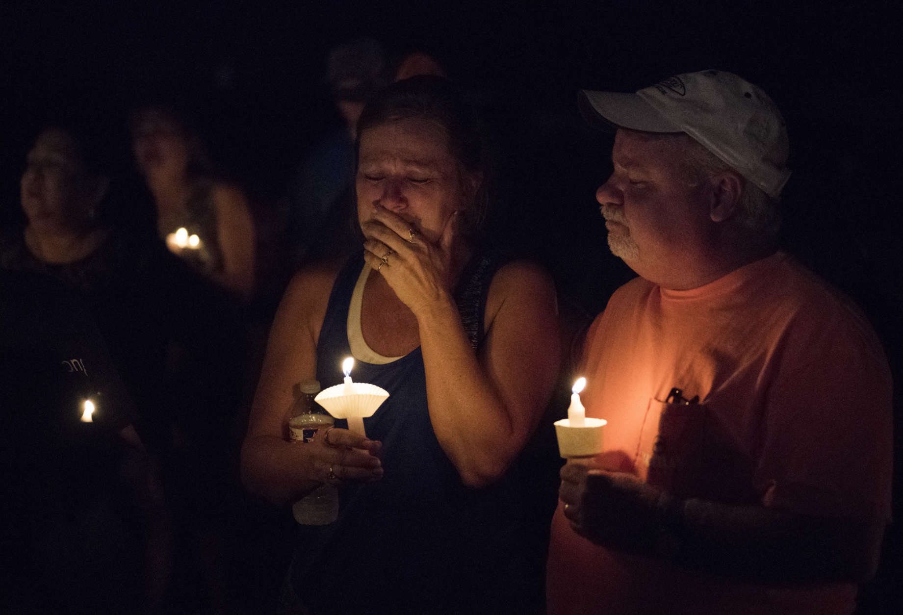 Mourners participate in a candlelight vigil for the victims of a fatal shooting at the First Baptist Church of Sutherland Springs, Sunday, Nov. 5, 2017, in Sutherland Springs, Texas. A man dressed in black tactical-style gear and armed with an assault rifle opened fire inside the church in the small South Texas community on Sunday, killing and wounding many. The dead ranged in age from 5 to 72 years old. (AP Photo/Darren Abate)