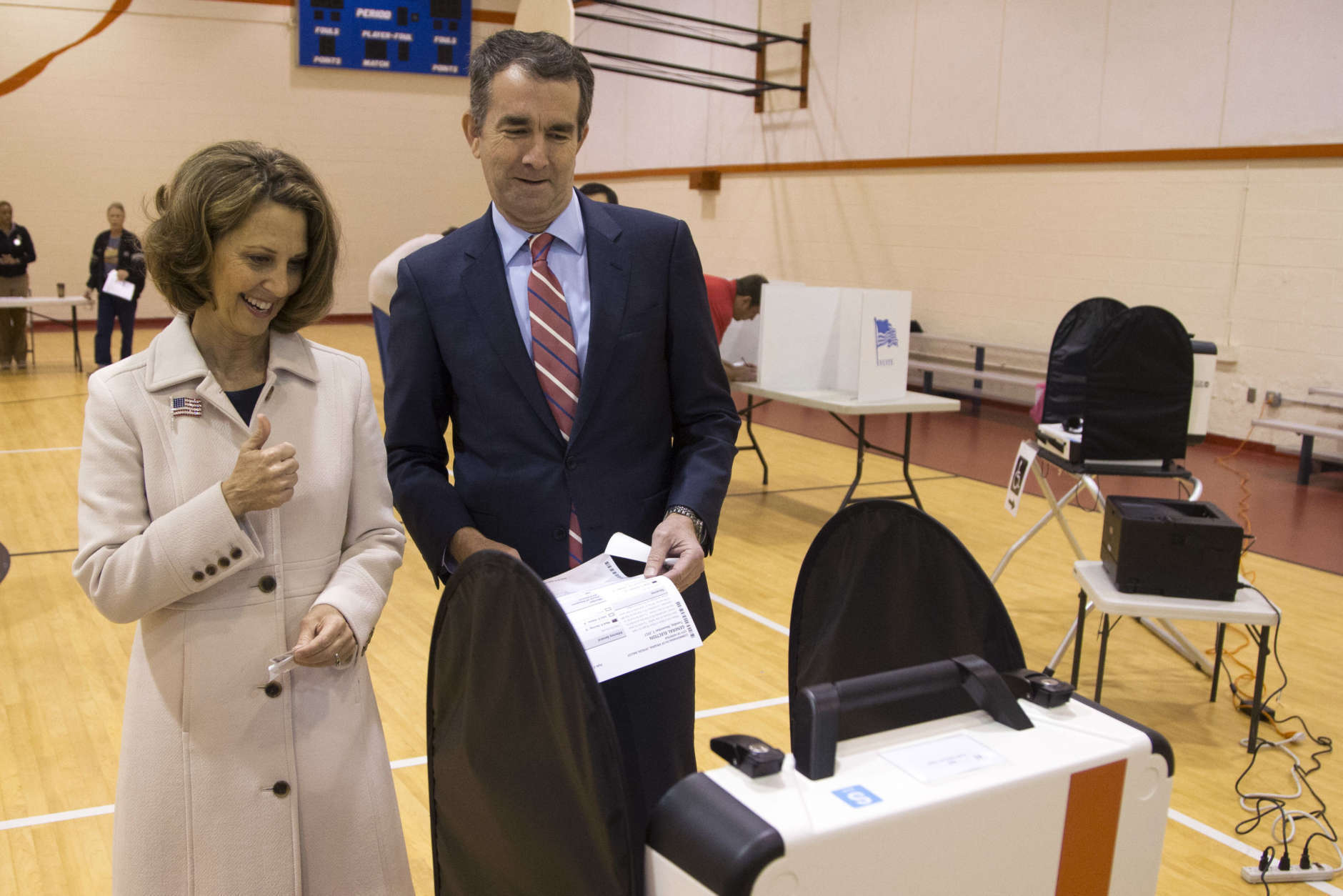 Democratic gubernatorial candidate Lt. Gov. Ralph Northam, and his wife, Pam, approach the vote tally machine as the vote in Norfolk, Va., Tuesday, Nov. 7, 2017. Northam faces Republican Ed Gillespie in today's election. (AP Photo/Steve Helber)