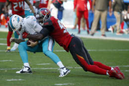 Tampa Bay Buccaneers defensive end Ryan Russell (95) sacks Miami Dolphins quarterback Jay Cutler (6), during the first half of an NFL football game, Sunday, Nov. 19, 2017, in Miami Gardens, Fla. (AP Photo/Wilfredo Lee)