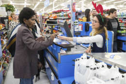 IMAGE DISTRIBUTED FOR WALMART - A Walmart associate assists a customer checking out during Black Friday events on Thursday, Nov. 23, 2017 in Bentonville, Ark. (Gunnar Rathbun/AP Images for Walmart)