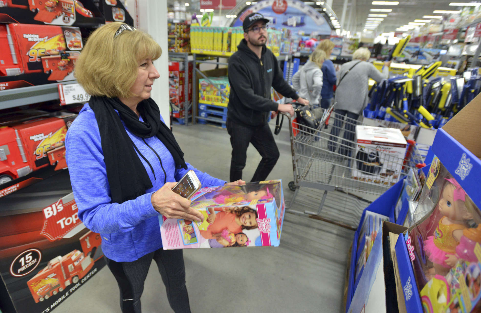 IMAGE DISTRIBUTED FOR BJ'S WHOLESALE CLUB - BJ's Wholesale Club member Kim Perion of Kingston, Mass., and her son Ben Krouse of Northborough, Mass., shop BJ's Top 10 Toys during the retailer's Black Friday Savings Event on Friday, Nov. 24, 2017 in Northborough, Mass. (Josh Reynolds/AP Images for BJ's Wholesale Club)