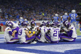 Minnesota Vikings players celebrate a Case Keenum touchdown by pretending to have Thanksgiving dinner in the end zone against the Detroit Lions during an NFL football game in Detroit, Thursday, Nov. 23, 2017. (AP Photo/Paul Sancya)