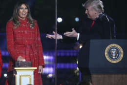 President Donald Trump gestures to first lady Melania Trump to light the 2017 National Christmas Tree on the Ellipse near the White House, Thursday, Nov. 30, 2017, in Washington. (AP Photo/Andrew Harnik)