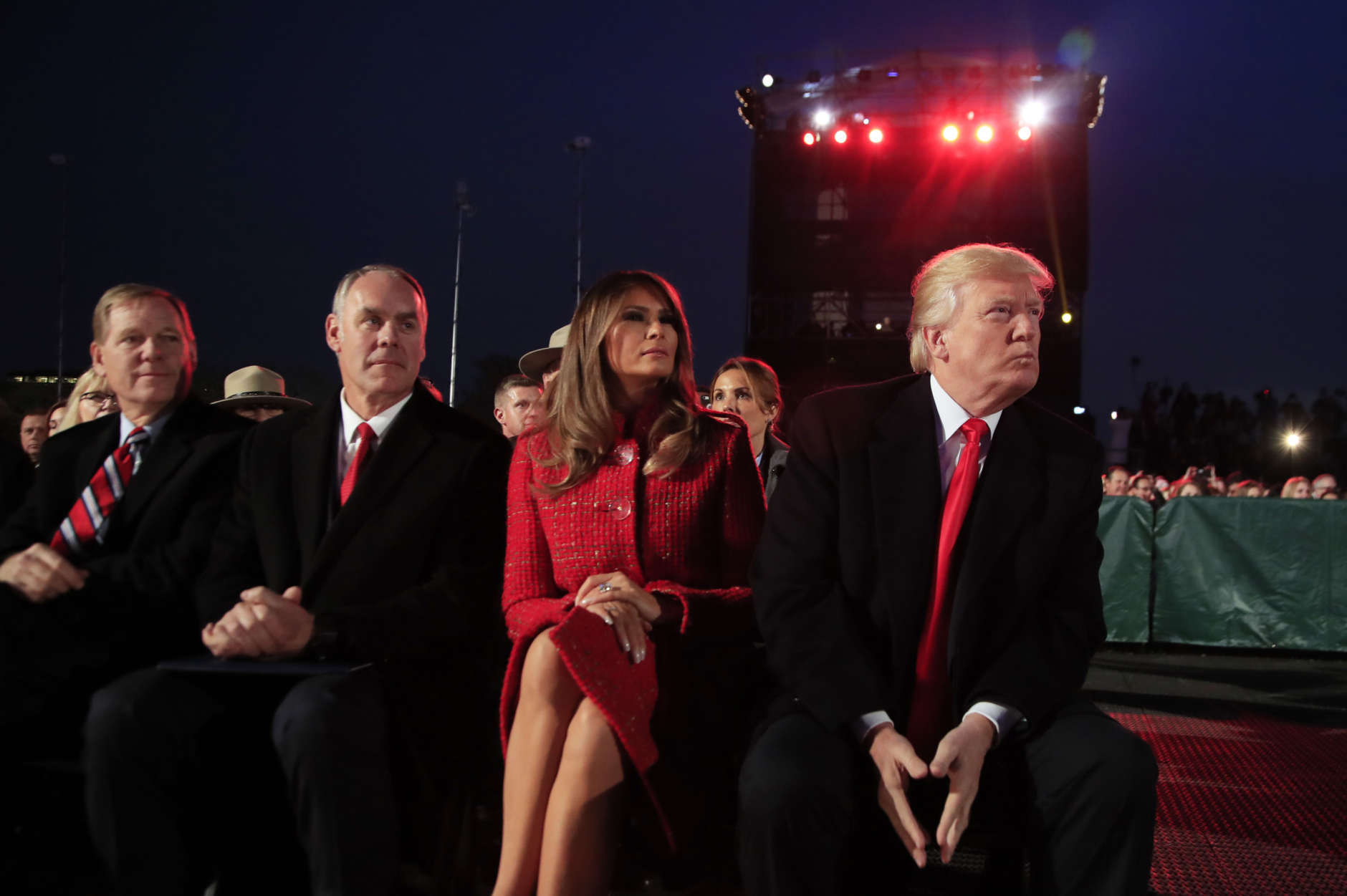President Donald Trump and first lady Melania Trump, watch performances during the National Christmas Tree lighting ceremony at the Ellipse near the White House in Washington, Thursday, Nov. 30, 2017, with Interior Secretary Ryan Zinke, second from left. (AP Photo/Manuel Balce Ceneta)