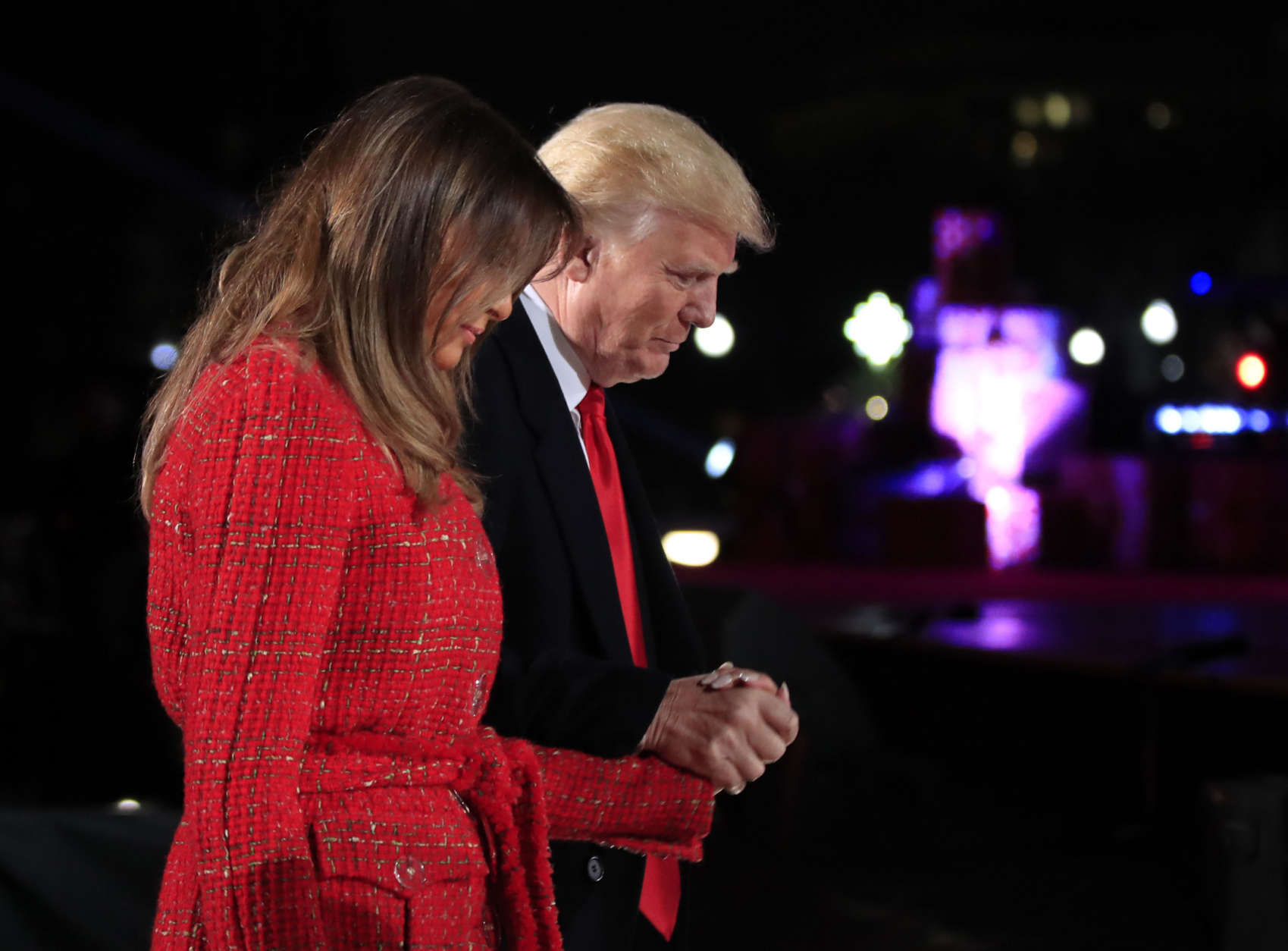 President Donald Trump holds first lady Melania Trump's hand as they walk back to the stage during the lighting ceremony for the 2017 National Christmas Tree on the Ellipse near the White House in Washington, Thursday, Nov. 30, 2017. (AP Photo/Manuel Balce Ceneta)