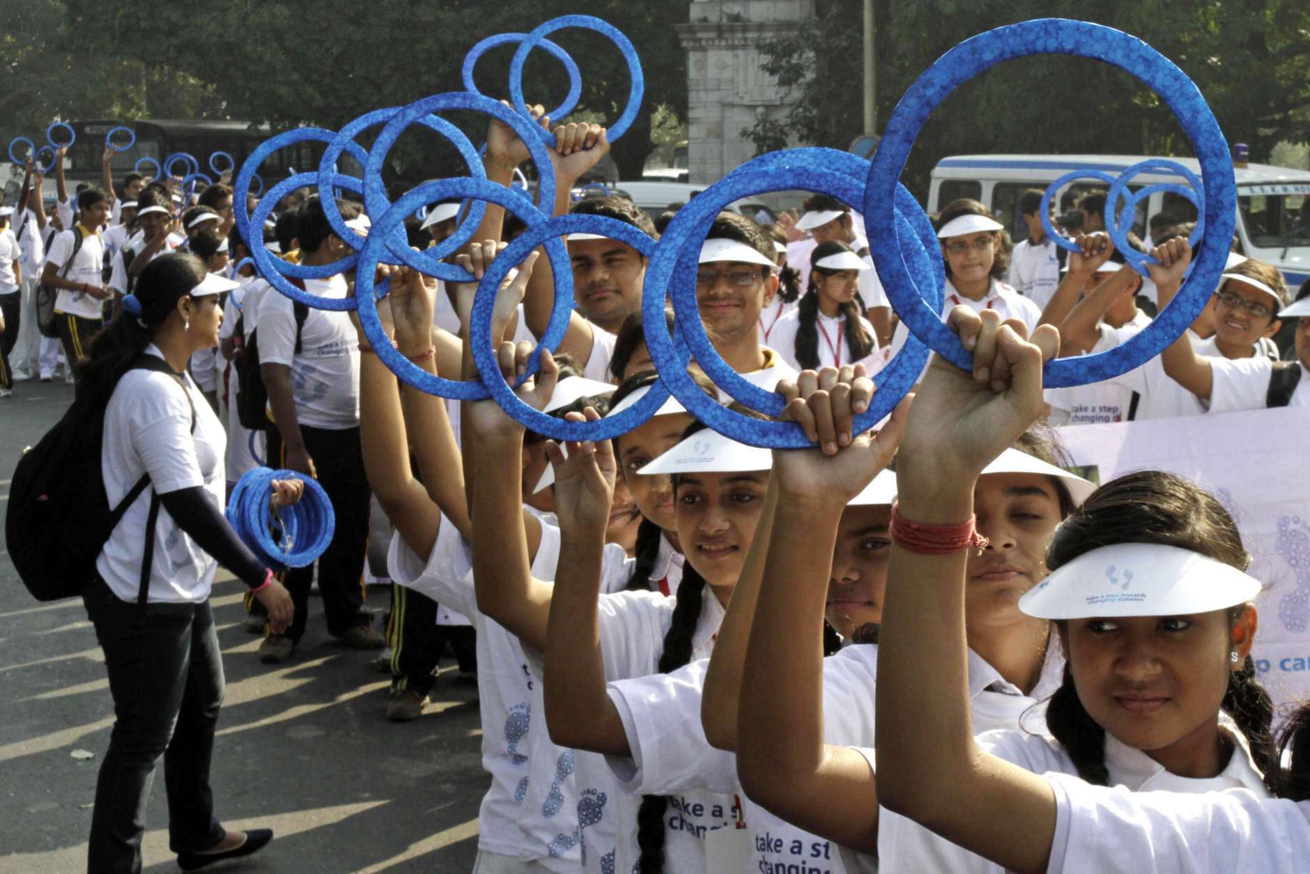 School students flash blue rings symbolic to diabetes during a rally on World Diabetes Day in Kolkata, India, Thursday, Nov. 14, 2013. (AP Photo/Bikas Das)