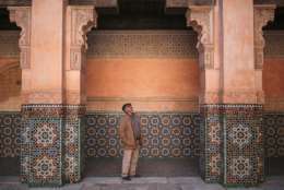 A tourist admires the columns of Ben Youssef Madrasa, Morocco's largest Madrasa, a traditional Islamic school, which was founded in the 14th century, in Marrakech, Morocco, Monday, Feb. 1, 2016. The Madrasa is famous for its Islamic calligraphy and colourful geometric tile work. (AP Photo/Mosa'ab Elshamy)