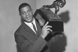 Ernie Davis, Syracuse University back, holds the Heisman Memorial Trophy which he receives Dec. 6, 1961 at a dinner in the Downtown Athletic club in New York City. The award is made annually to the nation's outstanding college football player. (AP Photo/Jack Harris)