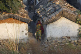 An Indian woman holds a bucket and walks to relieve herself in the open, on World Toilet Day on the outskirts of Jammu, India, Wednesday, Nov. 19, 2014. U.N. figures show of India's 1.2 billion people, 665 million, mostly those in the countryside, don't have access to a private toilet or latrine, something taken for granted in developed nations. Some villages have public bathrooms, but many women avoid using them because they are usually in a state of disrepair and because men often hang around and harass the women. (AP Photo/Channi Anand)