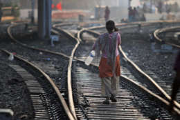 An Indian woman walks after defecating on a railway track, on World Toilet Day in Gauhati, India, Wednesday, Nov. 19 2014. India is considered to have the world's worst sanitation record despite spending some $3 billion since 1986 on sanitation programs, according to government figures. Building toilets in rural India, where hundreds of millions are still defecating outdoors, will not be enough to improve public health, according to a study published last month. (AP Photo/Anupam Nath)