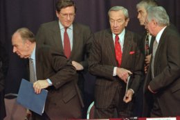 Secretary of State Warren Christopher, right center, steps between Bosnia President Alija Izetbegovic, left, and Croatian President Franjo Tudjman after they signed an accord Friday, Nov. 10, 1995, at Wright-Patterson Air Force Base in Dayton, Ohio, that bolsters a Muslim-Croat alliance that is seen as a fundamental building block for a Bosnia peace agreement. At left rear is U.S. negotiator Richard Holbrooke. (AP Photo/Al Behrman) 
