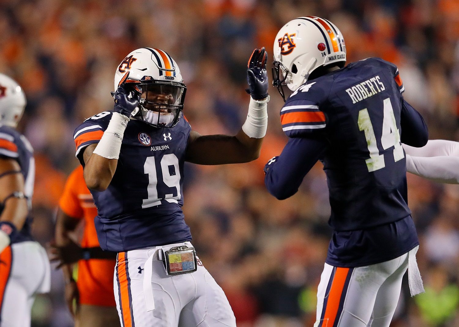AUBURN, AL - NOVEMBER 25:  Nick Ruffin #19 and Stephen Roberts #14 of the Auburn Tigers celebrate after the victory over the Alabama Crimson Tide at Jordan Hare Stadium on November 25, 2017 in Auburn, Alabama.  (Photo by Kevin C. Cox/Getty Images)
