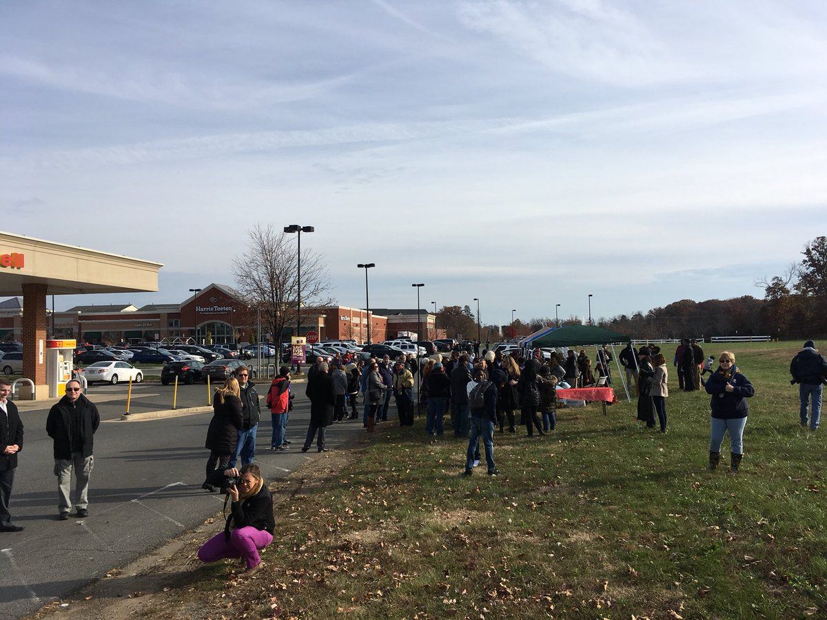 Dozens gather at the Harris Teeter parking lot on Belmont Ridge Road near Route 7. The Loudoun Freedom Center’s third annual wreath laying ceremony at Belmont Slave Cemetery was held Sunday. (WTOP/Liz Anderson)  