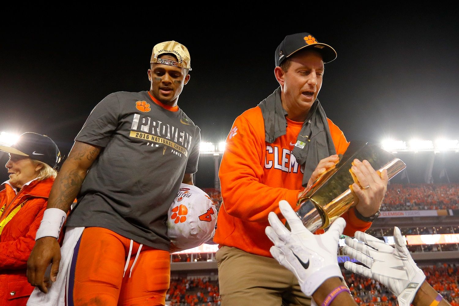 TAMPA, FL - JANUARY 09:  Quarterback Deshaun Watson #4 and head coach Dabo Swinney of the Clemson Tigers celebrate with the College Football Playoff National Championship Trophy after defeating the Alabama Crimson Tide 35-31 to win the 2017 College Football Playoff National Championship Game at Raymond James Stadium on January 9, 2017 in Tampa, Florida.  (Photo by Kevin C. Cox/Getty Images)