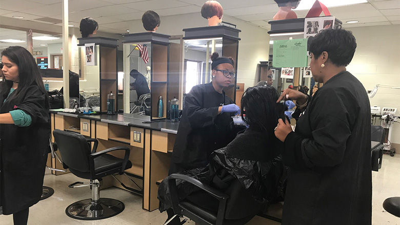 Cosmetology Teacher Carla Matthews teaches her students how to properly perform styling treatments according to state board on Thursday, November 2, 2017. (Georgia Slater/Capital News Service)