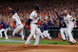 HOUSTON, TX - OCTOBER 30:  Derek Fisher #21 of the Houston Astros celebrates with Brian McCann #16 after scoring the winning run during the tenth inning against the Los Angeles Dodgers in game five of the 2017 World Series at Minute Maid Park on October 30, 2017 in Houston, Texas.  (Photo by Jamie Squire/Getty Images)