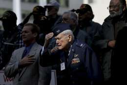 U.S. Air Force retired Col. James L. Wolfe, front, salutes stands with other veterans during the national anthem before a Veterans Day parade in Dallas, Friday, Nov. 10, 2017. (AP Photo/LM Otero)