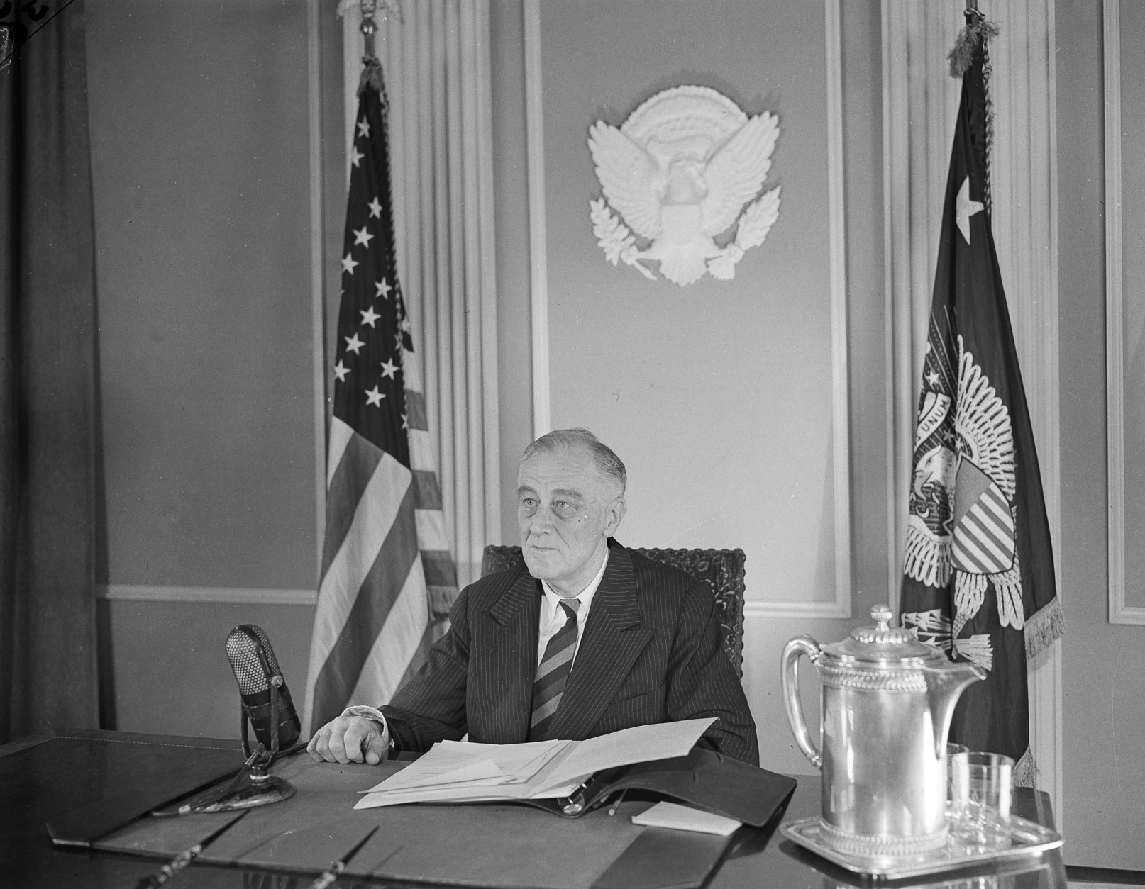 President Franklin D. Roosevelt sits before a microphone for the broadcast of the State of the Nation, Jan. 6, 1945, in which he called on the American people for greater exertion and sacrifice in the prosecution of the war, including a national service act and drafting of nurses. (AP Photo/B.I. Sanders)