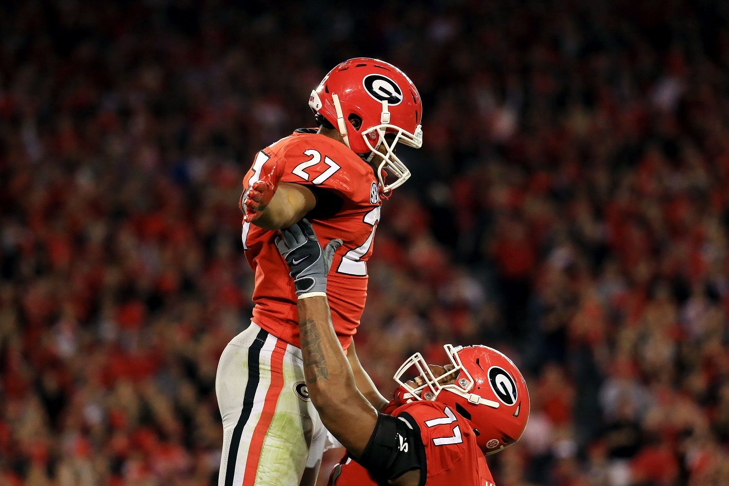 ATHENS, GA - NOVEMBER 18: Nick Chubb #27 of the Georgia Bulldogs celebrates a touchdown with Isaiah Wynn #77 during the second half against the Kentucky Wildcats at Sanford Stadium on November 18, 2017 in Athens, Georgia. (Photo by Daniel Shirey/Getty Images)