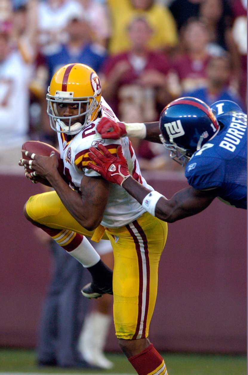LANDOVER, MD - SEPTEMBER 23: Sean Taylor #21 of the Washington Redskins is tackled by Plaxico Burress #17 of the New York Giants after intercepting a pass September 23, 2007 at FedEx Field in Landover, Maryland.  (Photo by Greg Fiume/Getty Images)