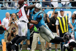 CHARLOTTE, NC - NOVEMBER 05:  Cam Newton #1 of the Carolina Panthers dives over Desmond Trufant #21 of the Atlanta Falcons for a touchdown in the second quarter during their game at Bank of America Stadium on November 5, 2017 in Charlotte, North Carolina.  (Photo by Streeter Lecka/Getty Images)