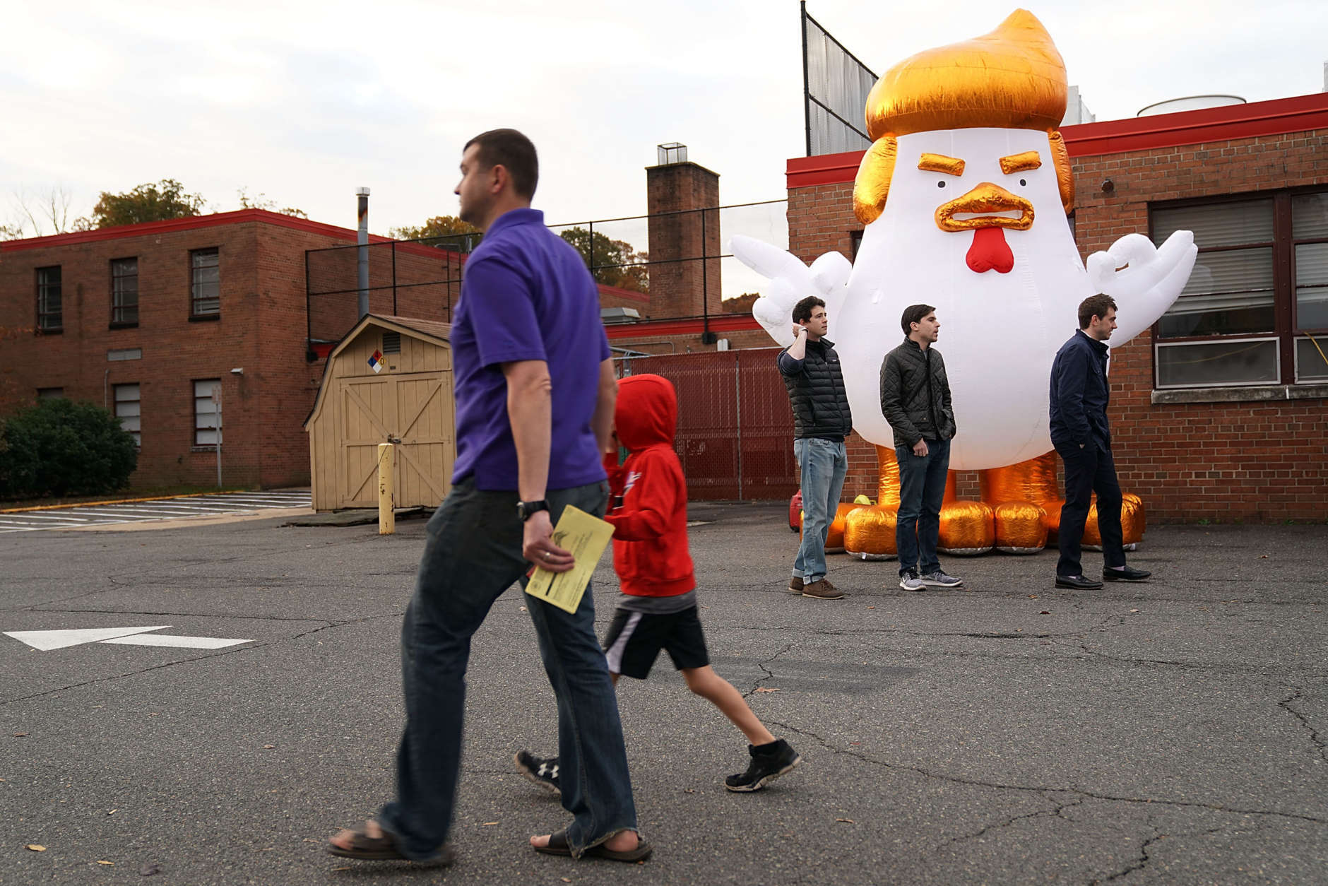 ALEXANDRIA, VA - NOVEMBER 07:  Supporters of Democrat Ralph Northam inflate a cartoon chicken made to resemble President Donald Trump outside the polling place at Washington Mill Elementary School November 7, 2017 in Alexandria, Virginia. (Photo by Chip Somodevilla/Getty Images)