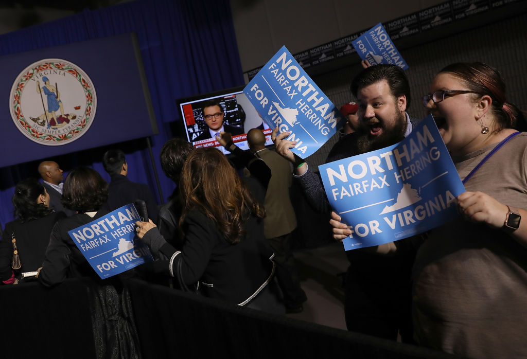 FAIRFAX, VA - NOVEMBER 07:  Supporters of Ralph Northam, the Democratic candidate for governor of Virginia, celebrate as early projections indicated a Northam victory at an election night rally November 7, 2017 in Fairfax, Virginia. Northam has fought a close race with Republican candidate Ed Gillespie.  (Photo by Win McNamee/Getty Images)