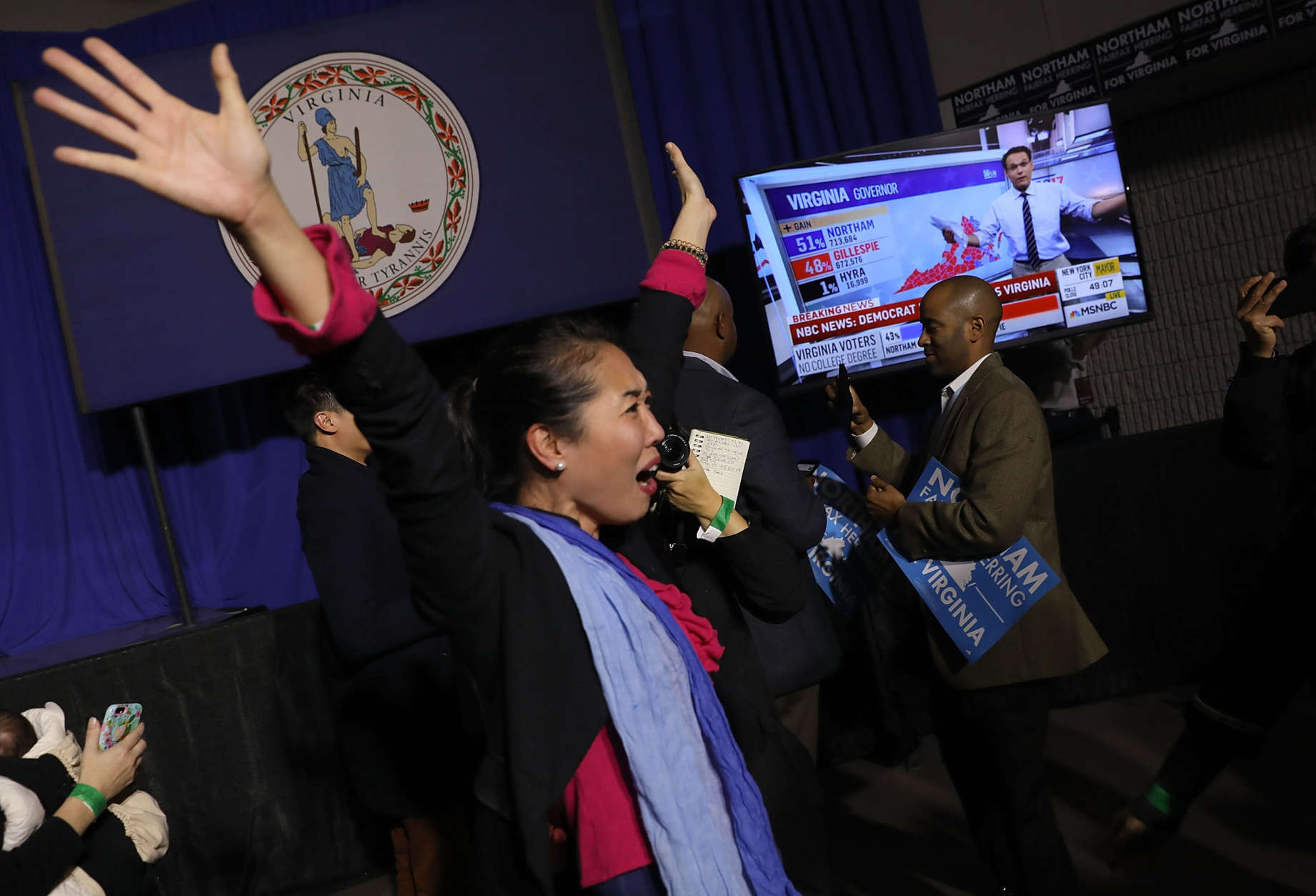 FAIRFAX, VA - NOVEMBER 07:  Hyun Lee, a supporter of Ralph Northam, the Democratic candidate for governor of Virginia, celebrates as early projections indicated a Northam victory at an election night rally November 7, 2017 in Fairfax, Virginia. Northam has fought a close race with Republican candidate Ed Gillespie.
 (Photo by Win McNamee/Getty Images)