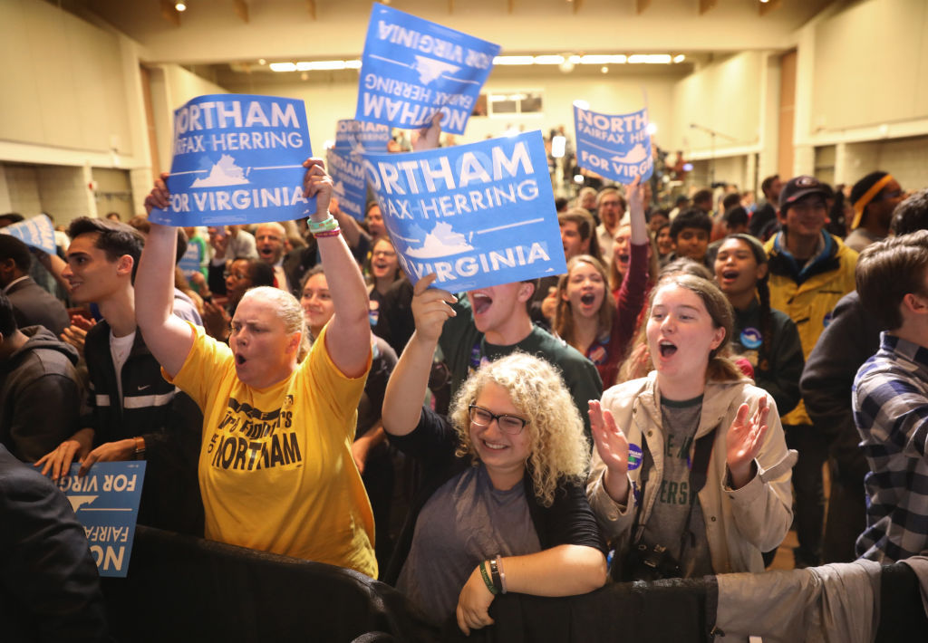 FAIRFAX, VA - NOVEMBER 07: Supporters of Ralph Northam, the Democratic candidate for governor of Virginia, celebrate as early projections indicated a Northam victory at an election night rally November 7, 2017 in Fairfax, Virginia. Northam has fought a close race with Republican candidate Ed Gillespie. (Photo by Win McNamee/Getty Images)