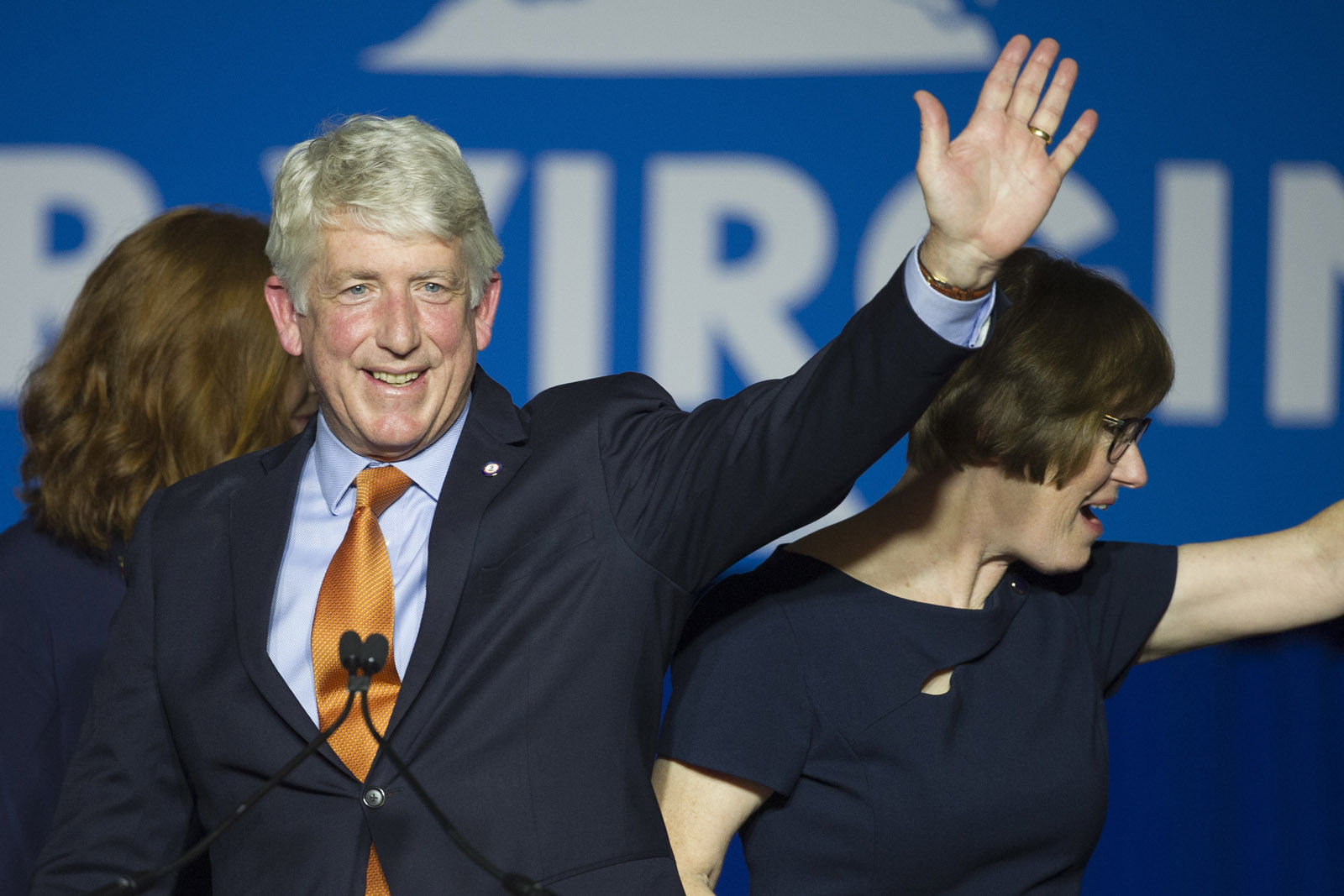 Democratic Attorney General Mark Herring and his wife Laura, right, celebrate his re-election with supporters at the Northam For Governor election night party at George Mason University in Fairfax, Va., Tuesday, Nov. 7, 2017. Herring won a second term as Virginia's attorney general Tuesday, beating back a challenge from Republican John Adams. (AP Photo/Cliff Owen)