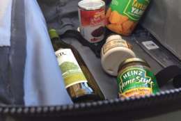 The TSA's Lisa Farbstein says, "If you can spill it, spray it, spread it, pump it or pour it, it's considered a liquid, gel or aerosol, and that should go in your checked bag if it's larger than 3.4 ounces." That includes cans -- so all these sauces and gravies need to be in a checked bag. (WTOP/Dennis Foley)