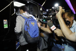 UCLA basketball player LiAngelo Ball gets into a van at Los Angeles International Airport on Tuesday, Nov. 14, 2017, in Los Angeles. Three UCLA basketball players detained in China on suspicion of shoplifting returned home, where they may be disciplined by the school as a result of the international scandal. (AP Photo/Jae C. Hong)
