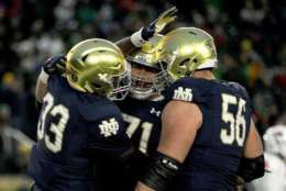 SOUTH BEND, IN - OCTOBER 28: Josh Adams #33, Alex Bars #71, and Quenton Nelson #56 of the Notre Dame Fighting Irish celebrate after scoring a touchdown in the third quarter against the North Carolina State Wolfpack at Notre Dame Stadium on October 28, 2017 in South Bend, Indiana. (Photo by Dylan Buell/Getty Images)