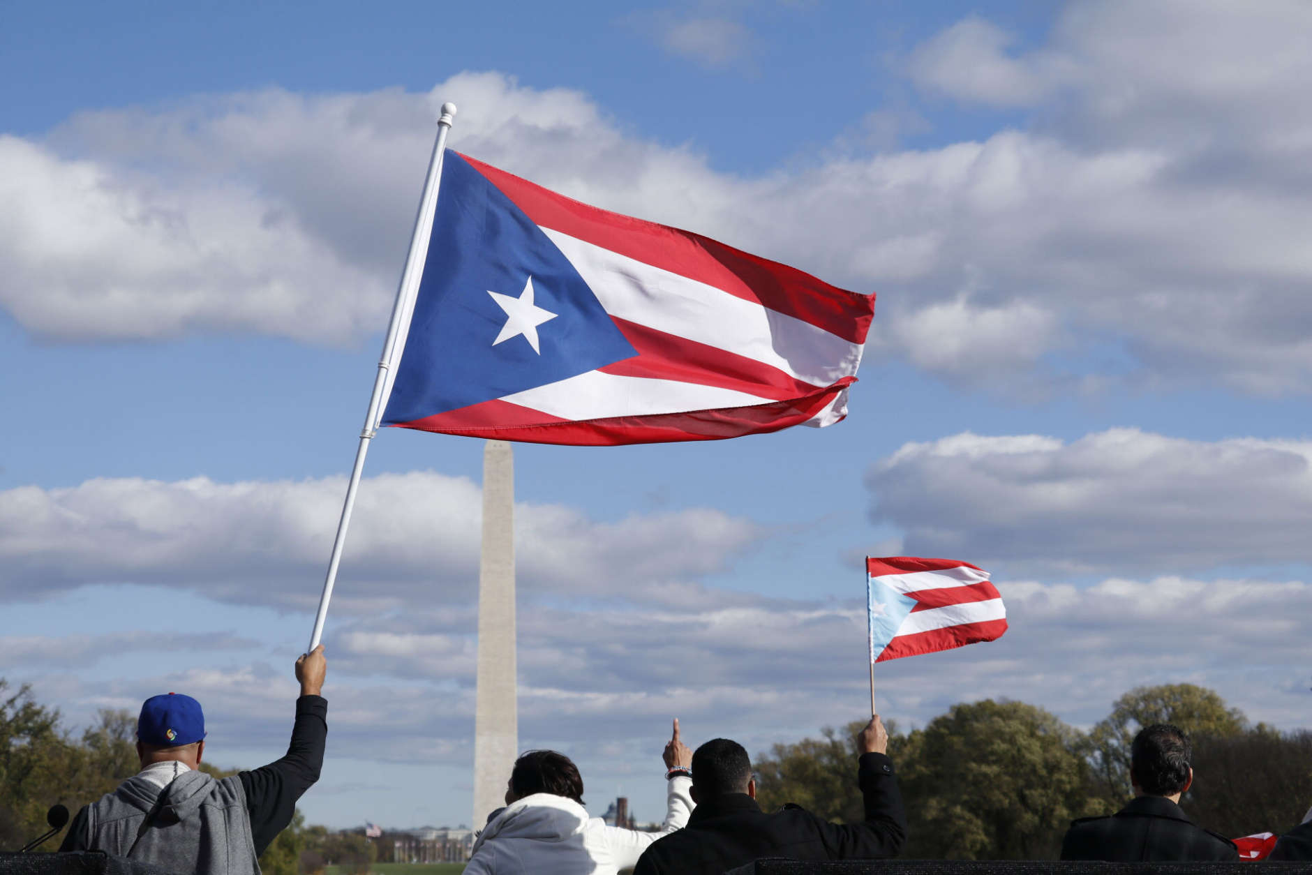 Marchers waved Puerto Rican flags during the March for Puerto Rico in Washington, D.C. on Sunday, Nov. 19. (WTOP/Kate Ryan)