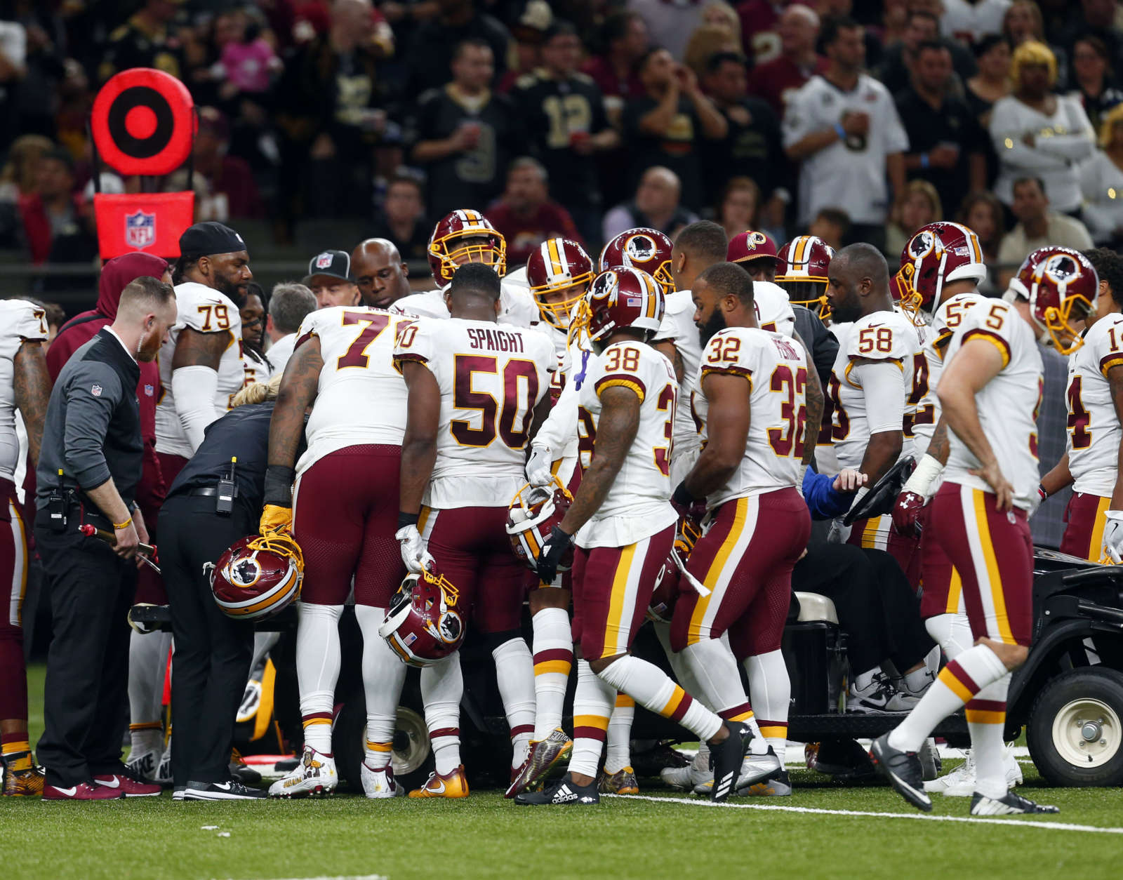 Teammates crowd around Washington Redskins running back Chris Thompson as he is helped onto a cart after being injured in the second half of an NFL football game against the New Orleans Saints in New Orleans, Sunday, Nov. 19, 2017. (AP Photo/Butch Dill)