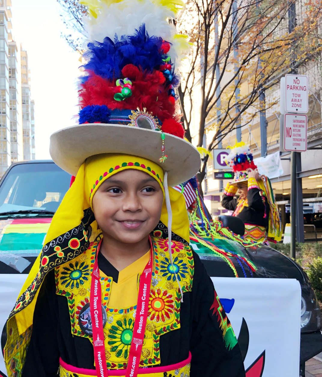 Rachel Saenz, 9, gets ready to march at the Reston Town Center Holiday Parade with Tinkus San Simon, a dance troupe that performs Bolivian dances. (WTOP/Kate Ryan)