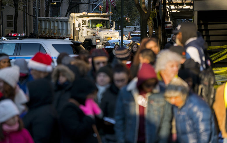 A large truck full of sand blocks a side street as people wait for the start of the Macy's Thanksgiving Day Parade in New York, Thursday, Nov. 23, 2017. (AP Photo/Craig Ruttle)