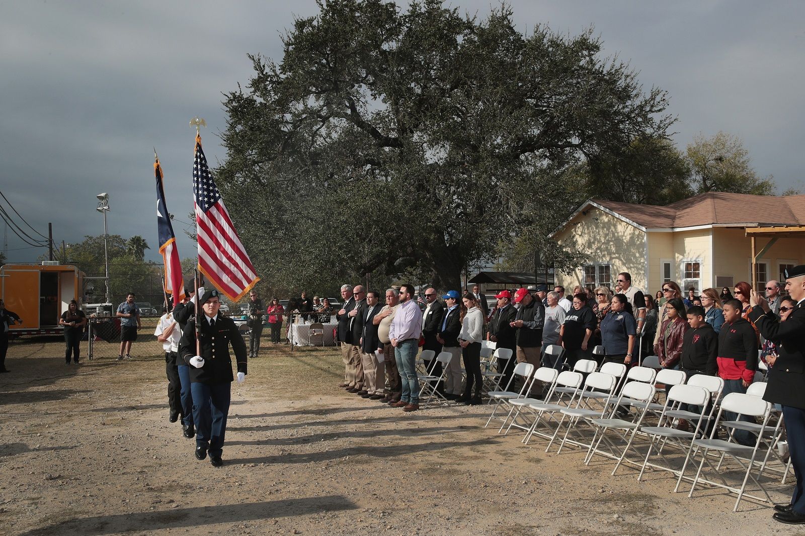 SUTHERLAND SPRINGS, TX - NOVEMBER 11:  A color guard presents colors during a Veterans Day ceremony outside the town's Community Center on November 11, 2017 in Sutherland Springs, Texas. Residents of the community are still trying to heal following the shooting at the First Baptist Church of Sutherland on November 5. Devin Patrick Kelley shot and killed 26 people and wounded 20 others when he opened fire during Sunday service at the church.  (Photo by Scott Olson/Getty Images)