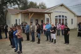 SUTHERLAND SPRINGS, TX - NOVEMBER 11: Residents and visitors share a prayer during a Veterans Day ceremony outside the Community Center on November 11, 2017 in Sutherland Springs, Texas. Residents of the community are still trying to heal following the shooting at the First Baptist Church of Sutherland Springs on November 5. Devin Patrick Kelley shot and killed 26 people and wounded 20 others when he opened fire during Sunday service at the church.  (Photo by Scott Olson/Getty Images)