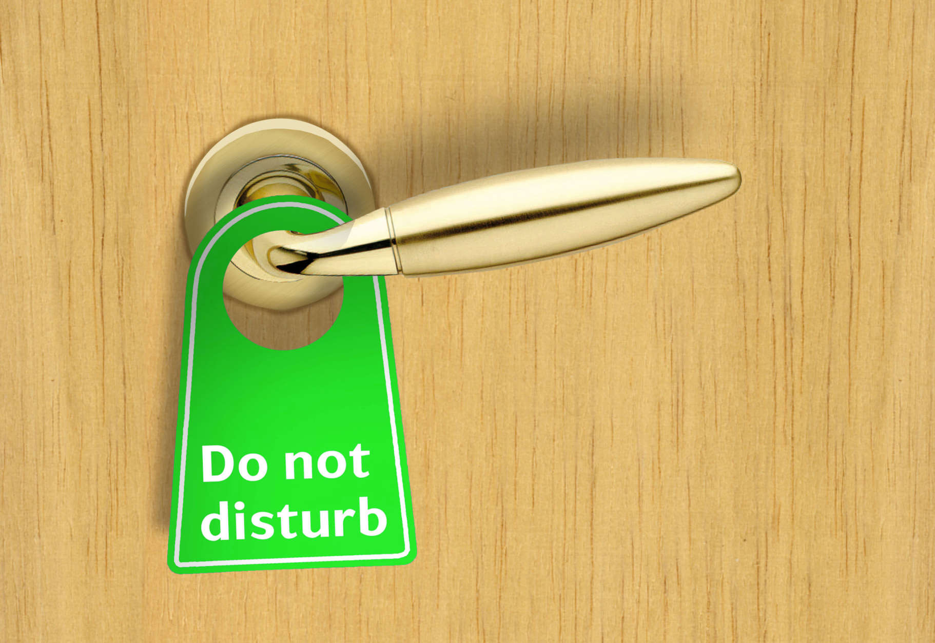 Hotel wood door with a Do not disturb sign