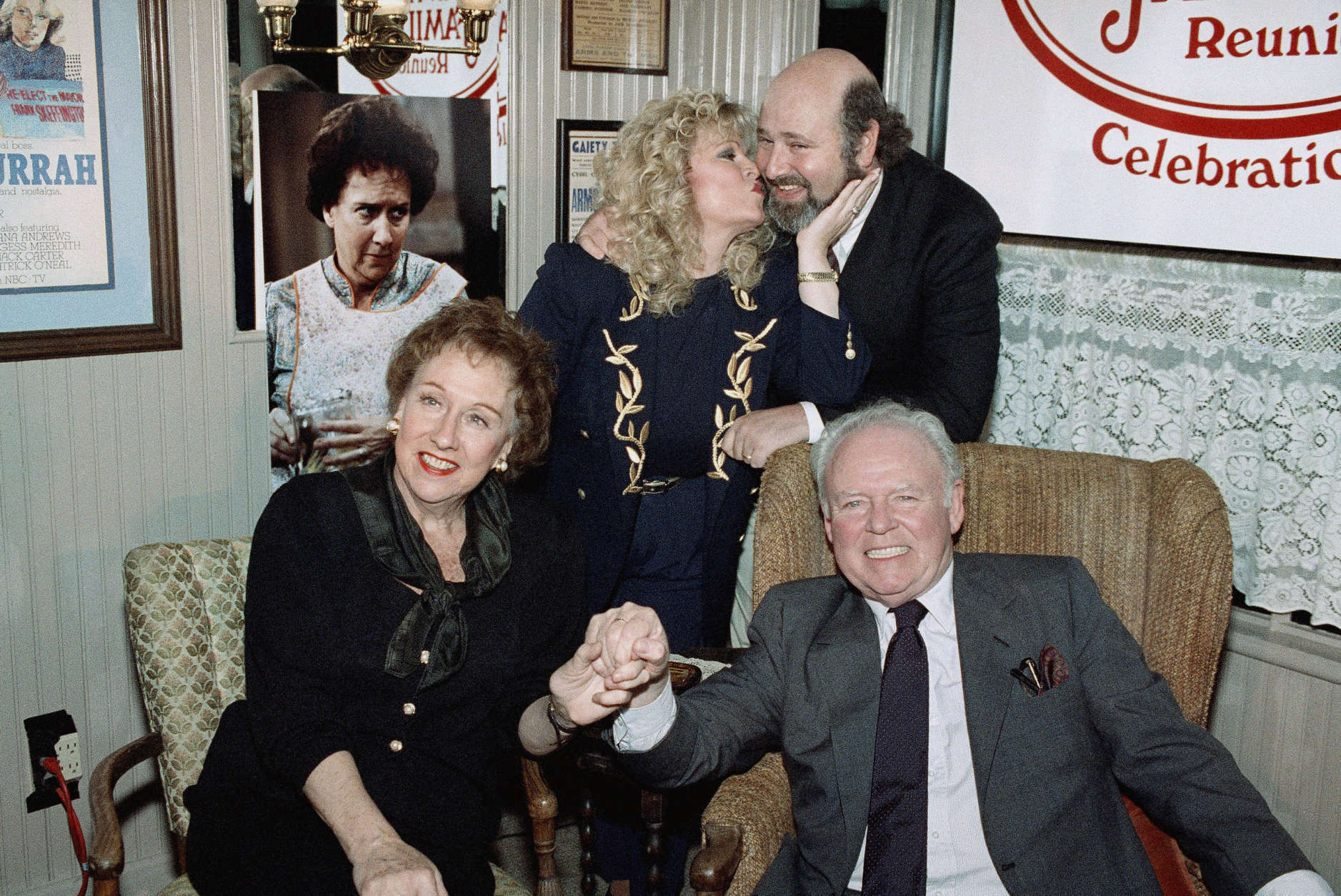 Sally Struthers plants a kiss on the cheek of Rob Reiner, right, Carroll O'Connor and Jean Stapleton hold hands during a reunion of the cast of ?All in the Family? at O?Conner restaurant, Monday, Feb. 12, 1991 in Beverly Hill, Calif. The Archie Bunker household returns to television in a 90-minute 20th anniversary special featuring highlights of series, Saturday on CBS. (AP Photo/Chris Martinez)