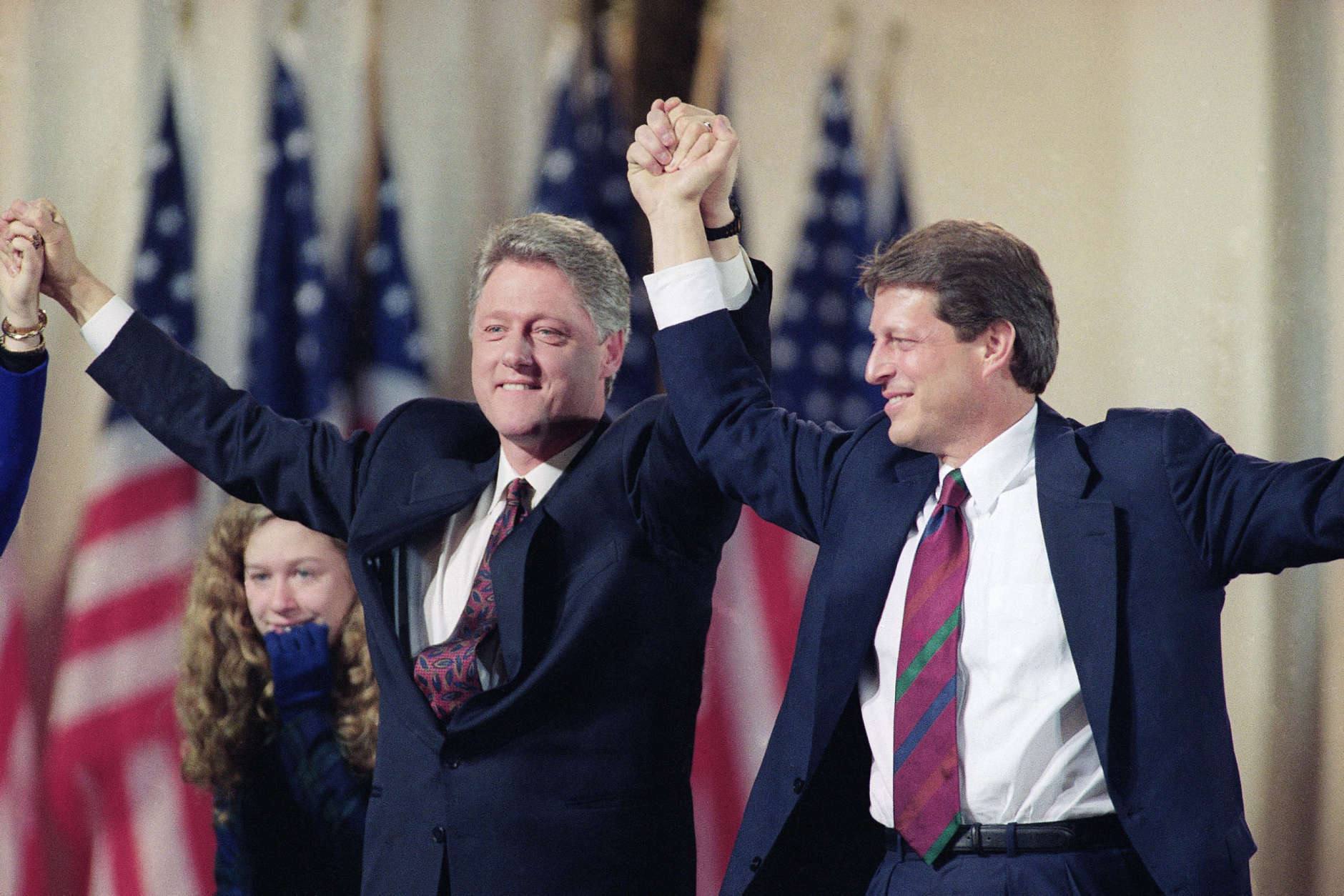 Bill Clinton with Al Gore raise hands in victory after landslide election in Little Rock, Arkansas on November 3, 1992. (AP Photo)