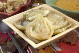 This Oct. 12, 2010 photo shows braised fresh fennel with rosemary. The sweet flavor of fresh fennel becomes concentrated with luxurious results in this easy braised holiday side dish.    (AP Photo/Larry Crowe)