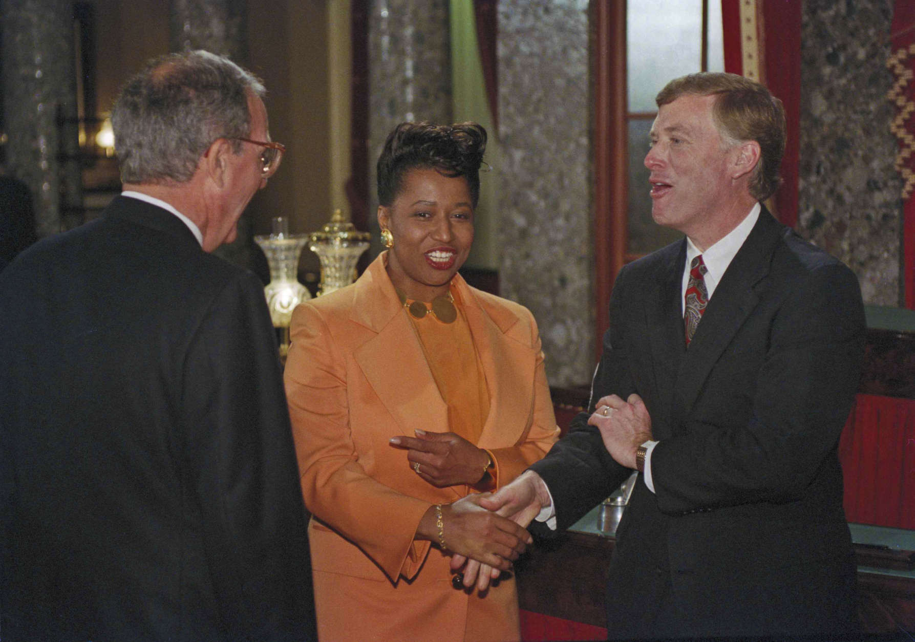 Carol Moseley Braun, D-Illinois, shakes hands with Vice President Dan Quayle after reenacting the taking of the Senate oath on Capitol Hill, January 5, 1993. Senate Majority Leader George Mitchell of Maine, looks on at left. Braun became the first black woman to become a member of the Senate. ( AP Photo/ Ron Edmonds )